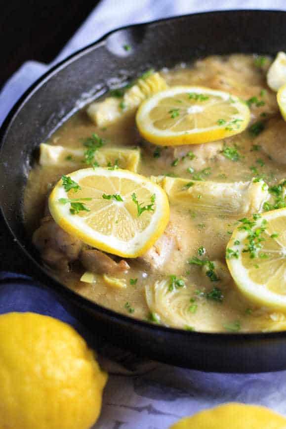 Chicken, Artichokes and Lemon in a cast iron skillet ready to serve