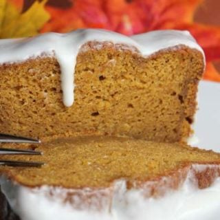 a large slice of pumpkin bread with frosting