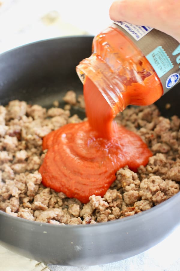 marinara sauce over cooked sausage