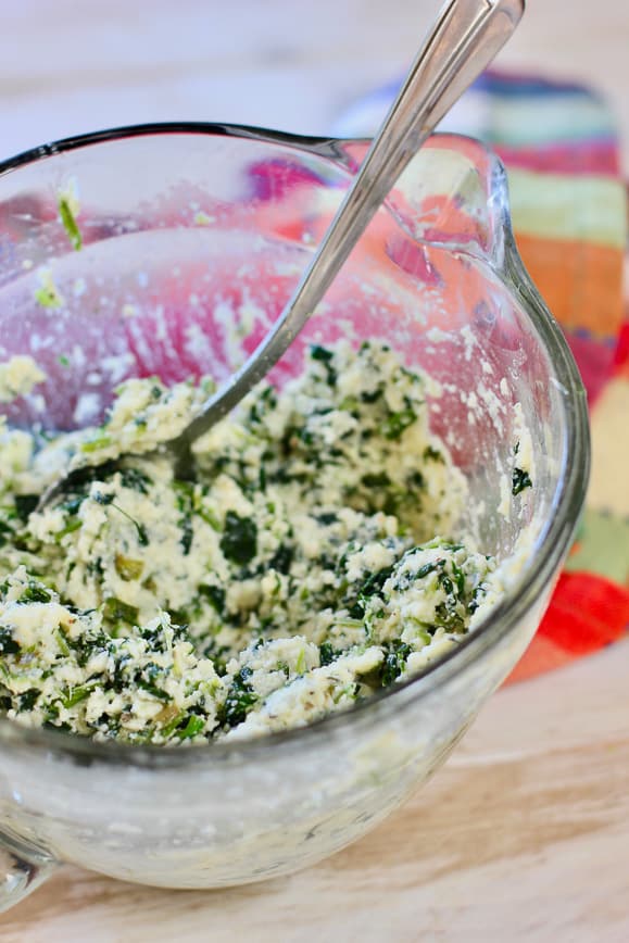 Spinach and Ricotta combined in a glass bowl