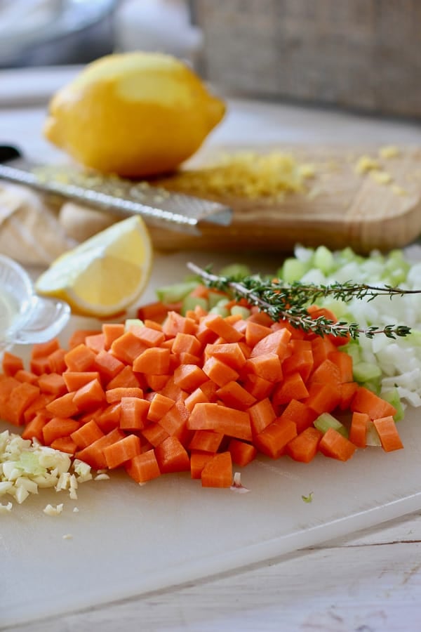 mirepoix, fresh time and lemon on a cutting board