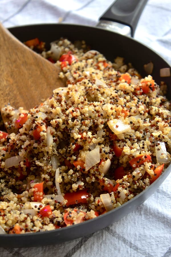pan full of quinoa red bell pepper and onion