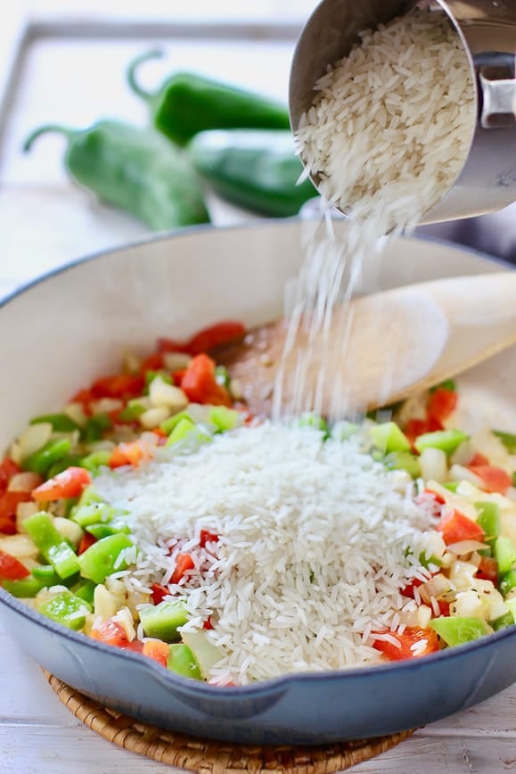 Uncooked rice added to the veggies while making Spanish Rice