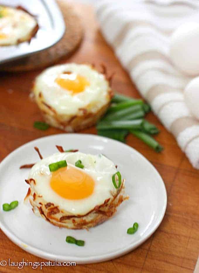 Eggs nestled into cups made of hash browns