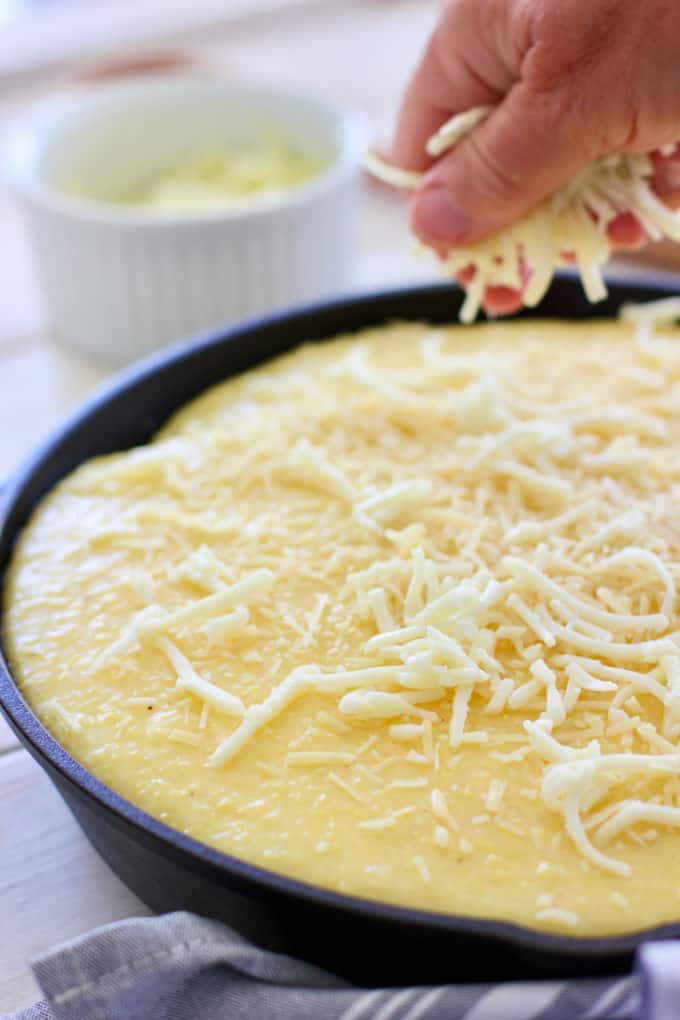 sprinkle polenta pie with more cheese