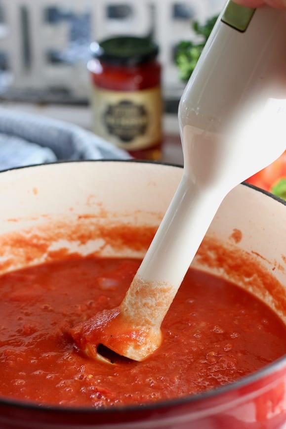 Tomato soup being purred with immersion blender