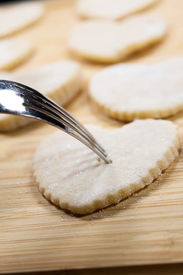 a cream wafer with a fork going through it to eliminate bubbles when baking