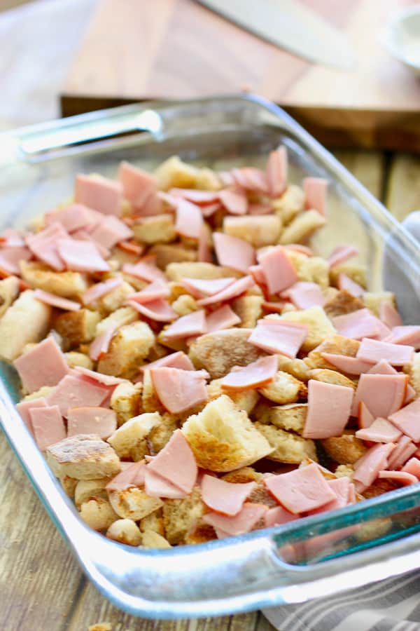 toasted english muffins and canadian bacon in a large pan