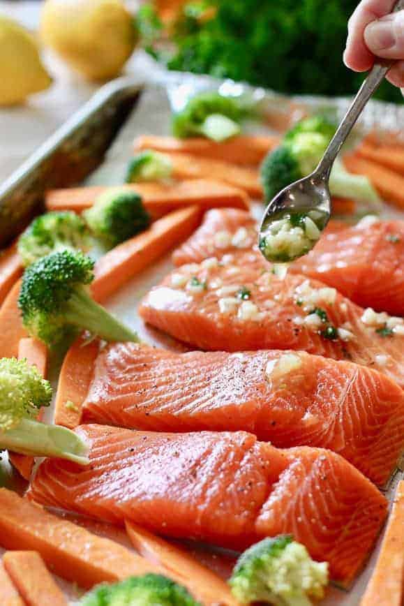 Fresh salmon fillets being prepared to bake