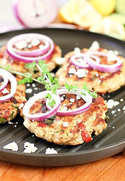 burgers on a grill pan with onion and spices