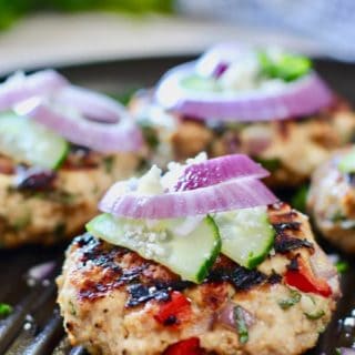 greek chicken burger with cucumber on a grill pan