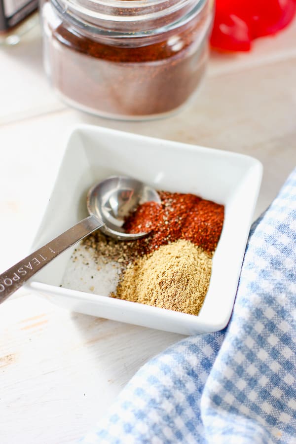 cumin, chili powder, salt and pepper in a small white bowl