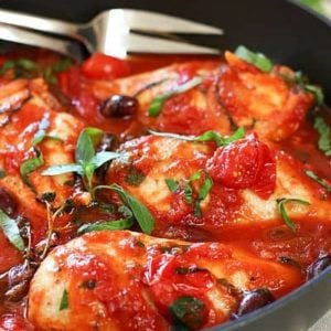 Chicken Puttanesca in a black skillet