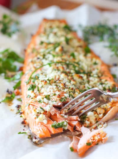 salmon on a sheet pan with a fork