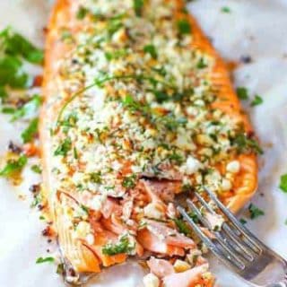 salmon crusted with herbs and feta on a sheet pan