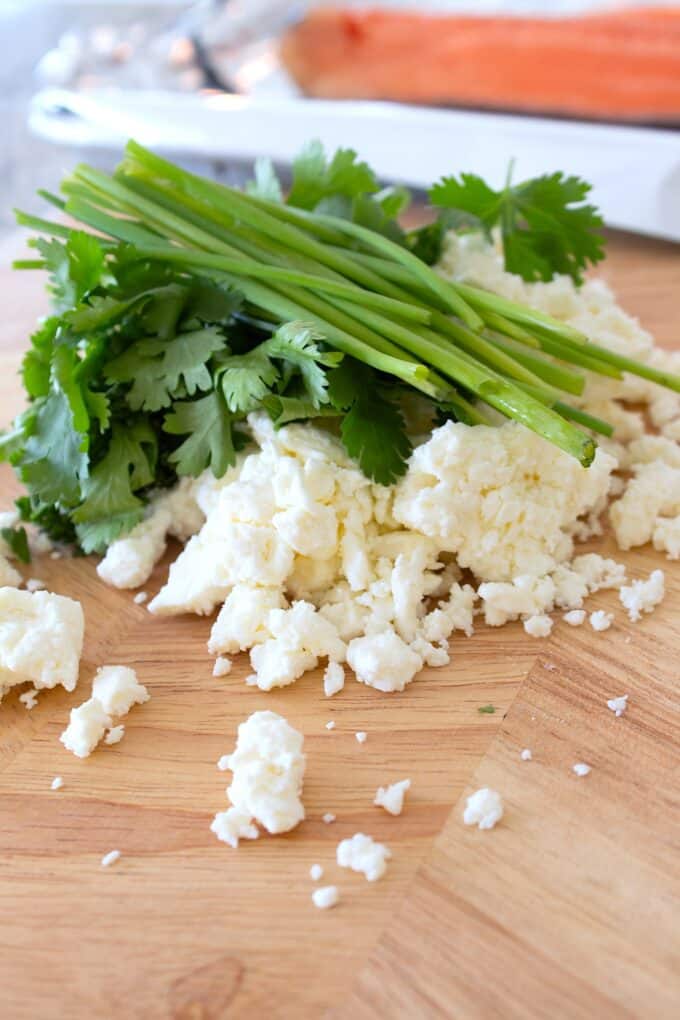 feta and fresh herbs on a cutting board