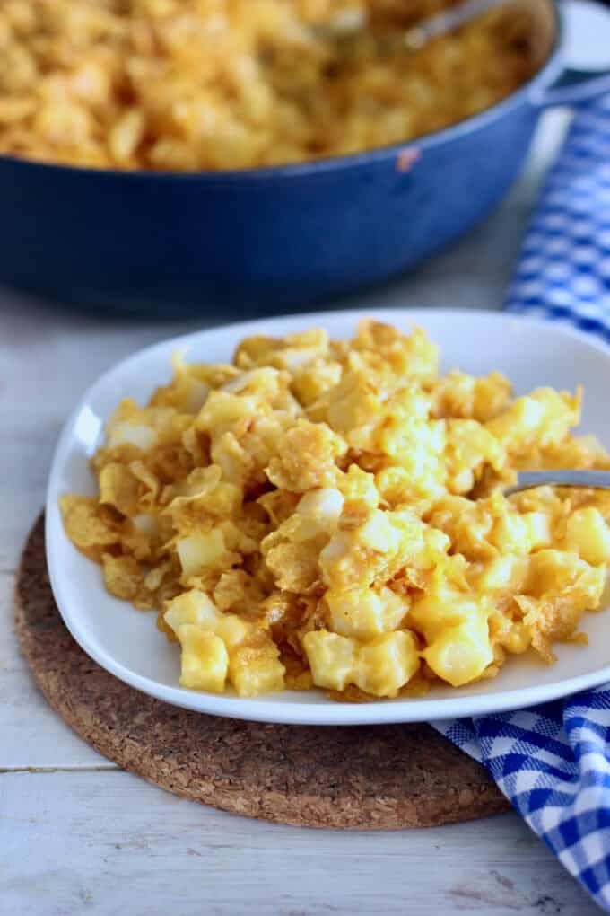 Cheesy potatoes on a small white plate