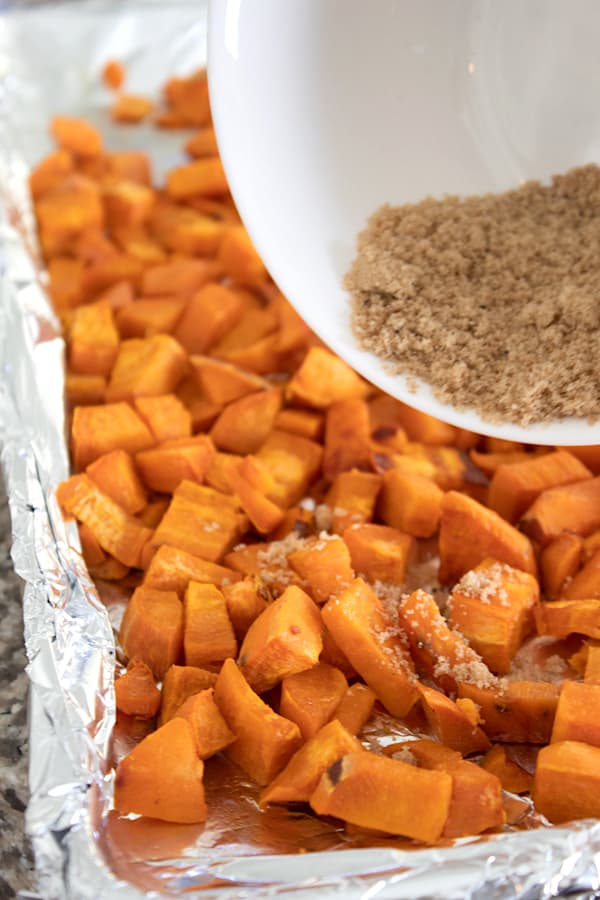 adding brown sugar to sweet potatoes