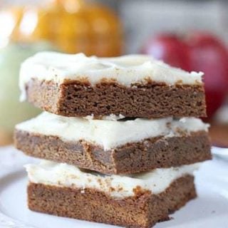 gingerbread bars stacked up on a white plate