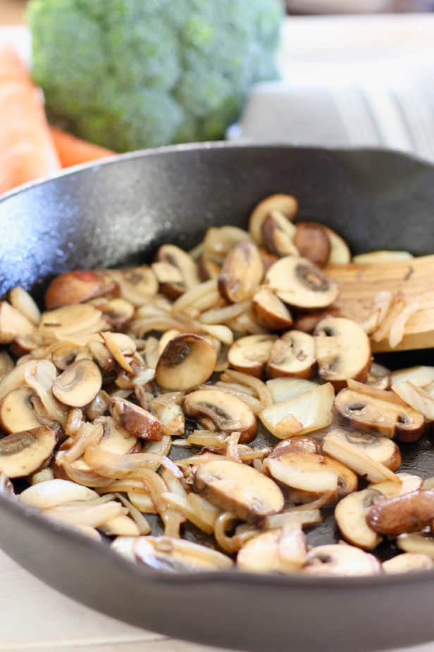 cooking up onions and mushroom in cast iron skillet