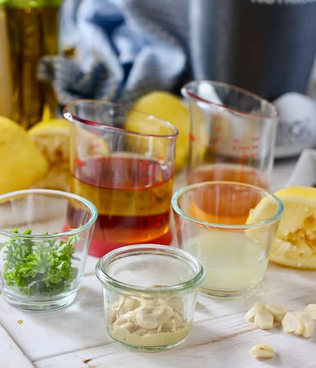 Dijon, lemon, oil and herbs all ready to make Lemon Dijon Vinaigrette