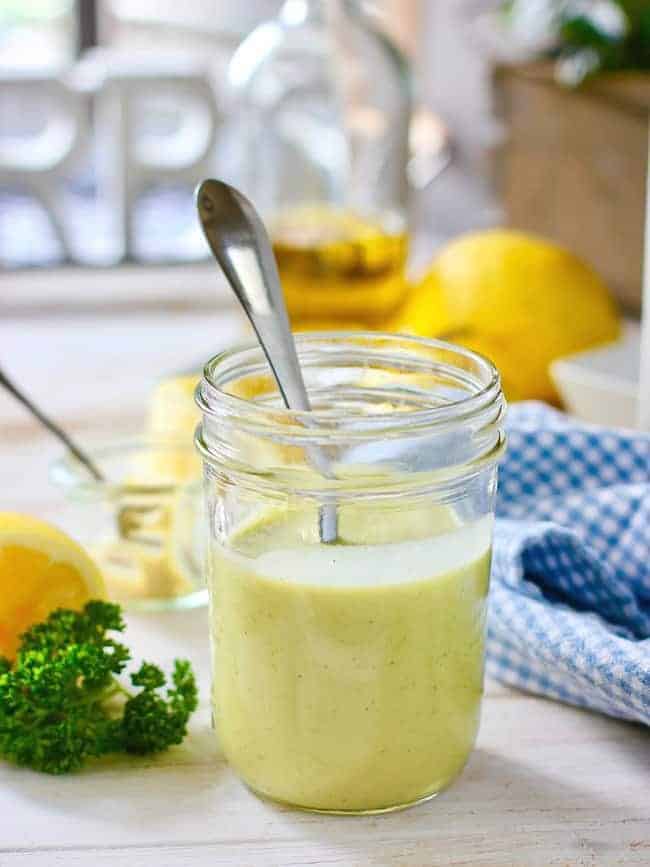 Lemon Dijon Vinaigrette in a mason jar with a spoon
