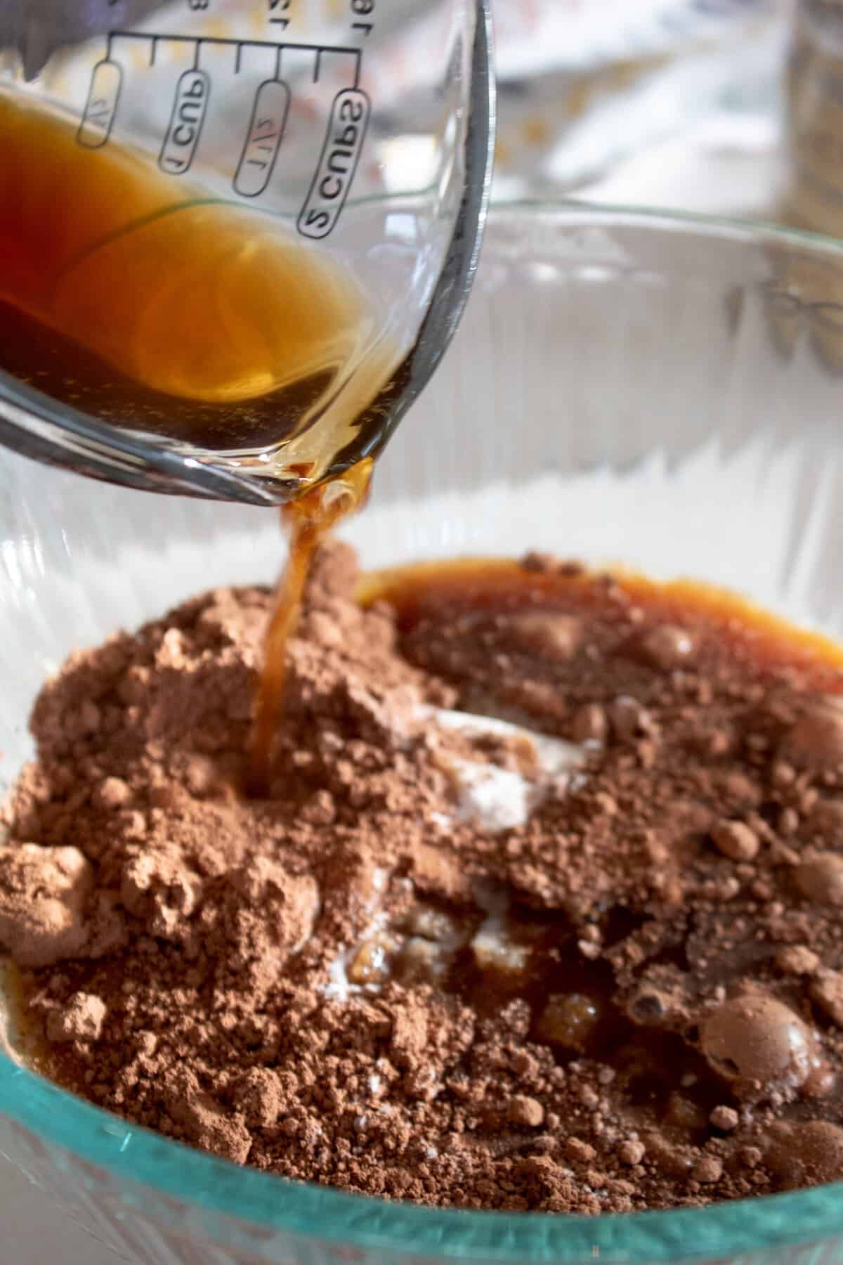 pouring coffee into cupcake brownie batter