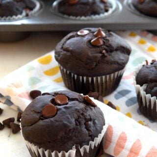 brownie cupcakes on a dish towel with chocolate chips