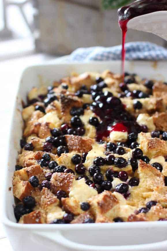 Blueberry syrup poured over french toast casserole 