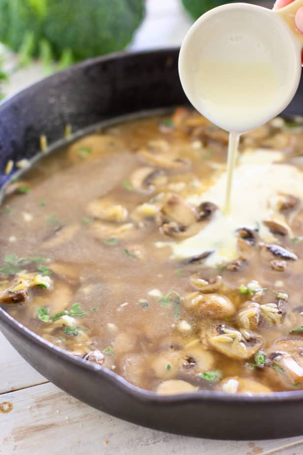 adding cream to skillet chicken and orzo