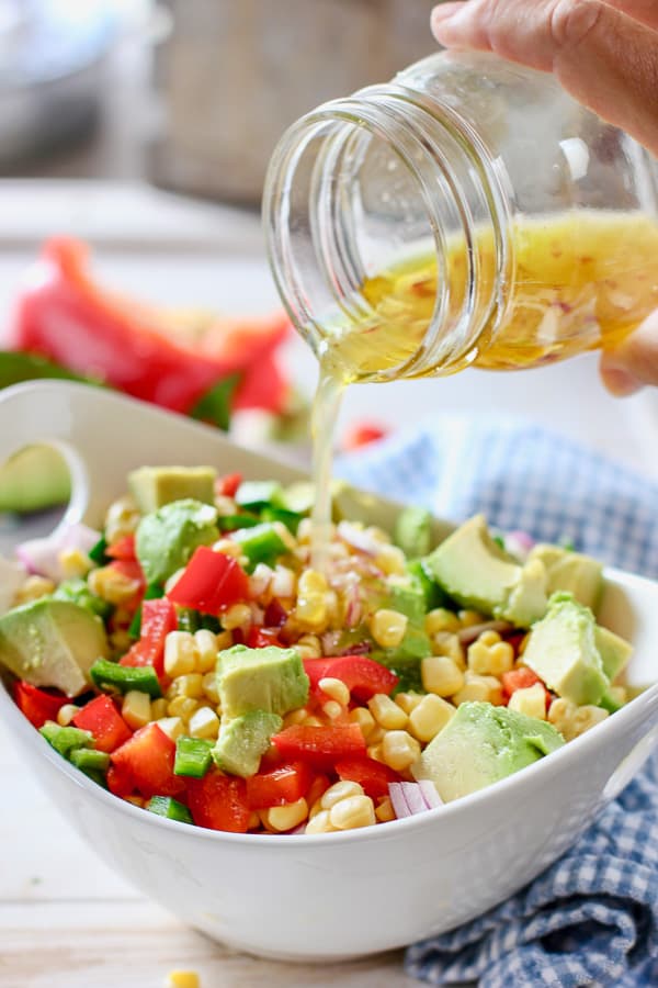 honey lime vinaigrette poured onto fresh corn salad