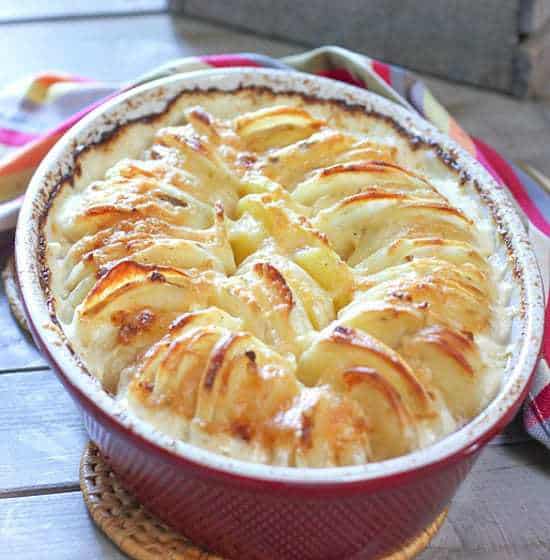 Beautiful baked augratin potatoes in a red casserole dish