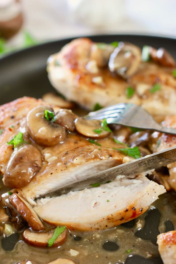 Chicken with mushroom pan sauce being sliced