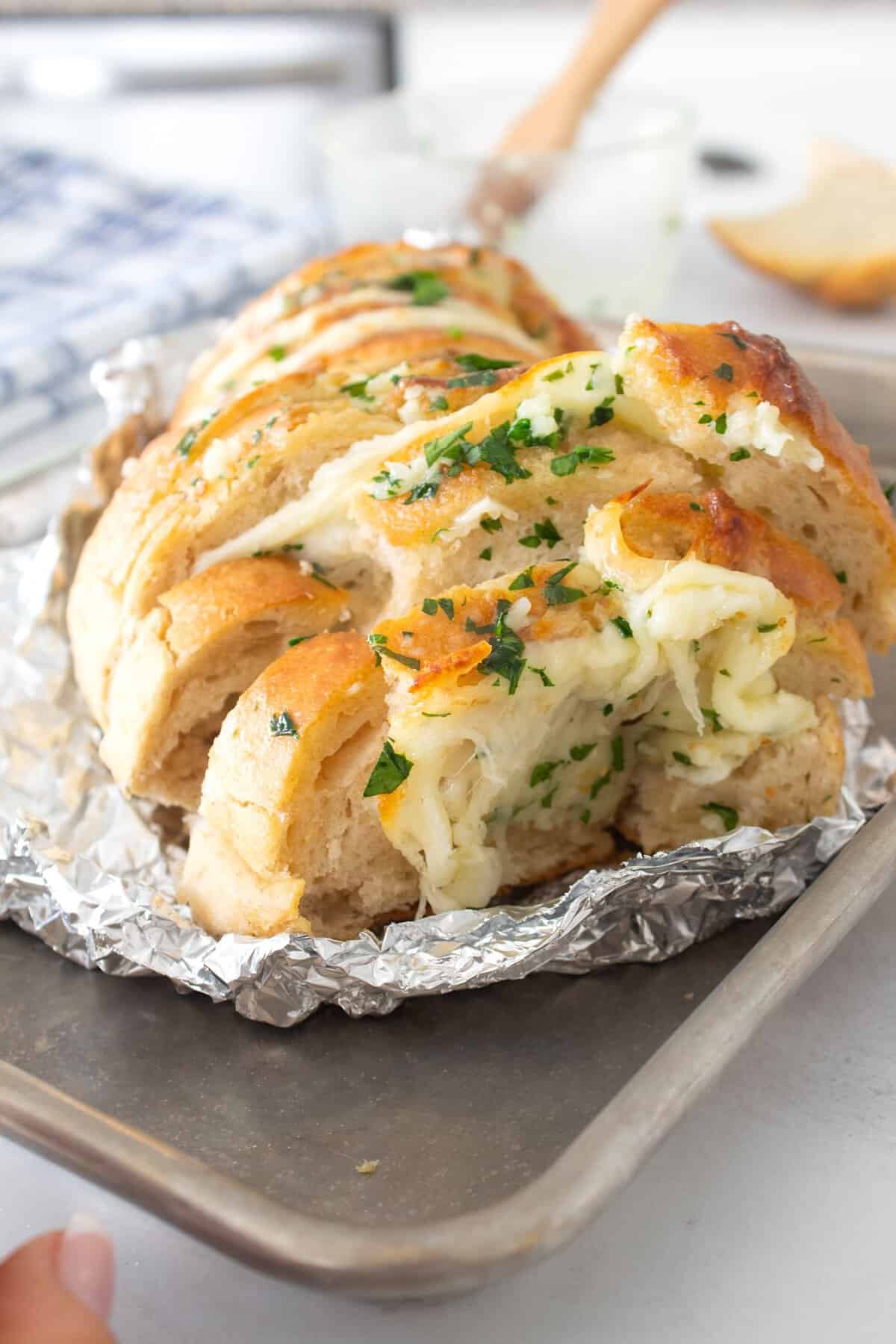 full view of cheesy garlic bread wrapped in foil