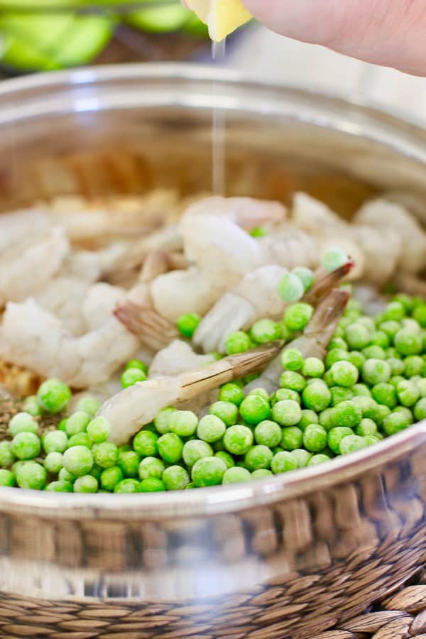broth shrimp and peas being combined 