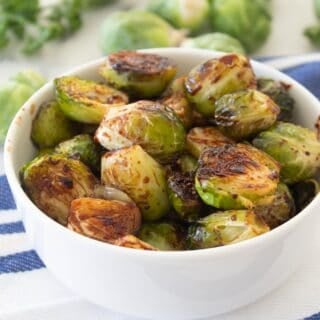 close up of balsamic roasted brussels sprouts in a bowl