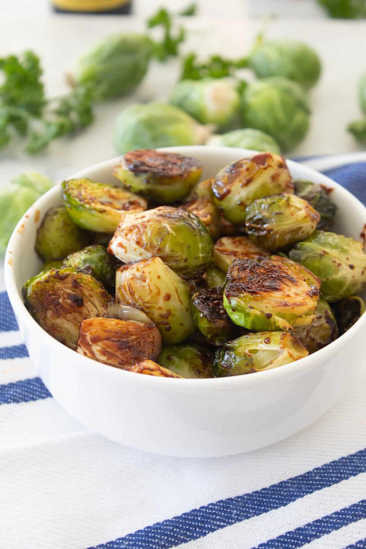 close up of balsamic roasted brussels sprouts in a bowl
