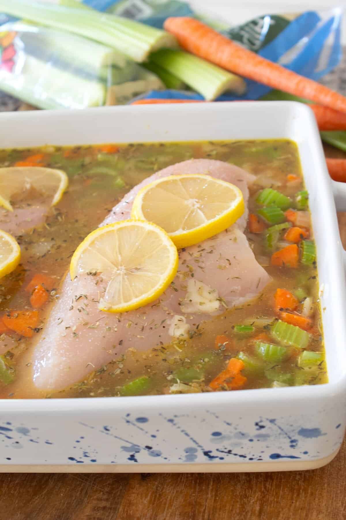 baking chicken and rice with broth in a baking dish