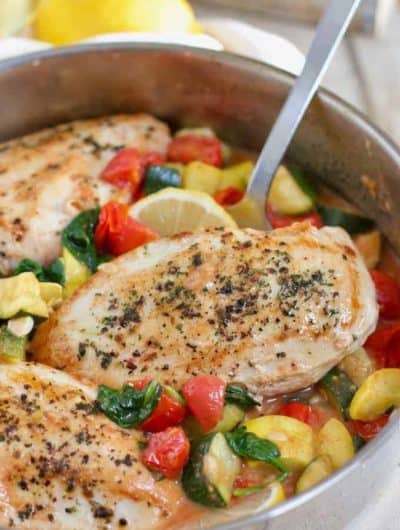 Italian chicken skillet in a silver pan with a spatula