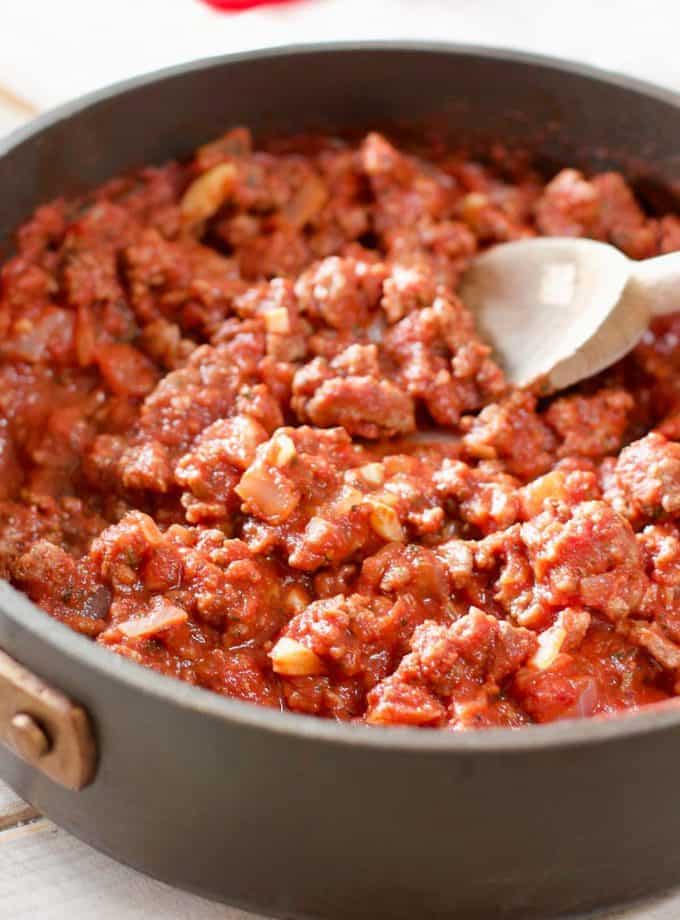 ground beef in a skillet with tomato sauce