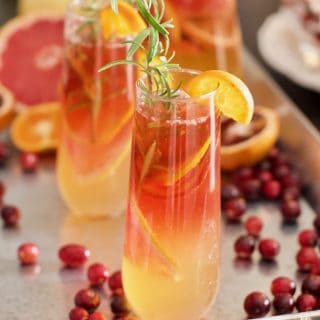 a beautiful citrus cocktail with cranberries