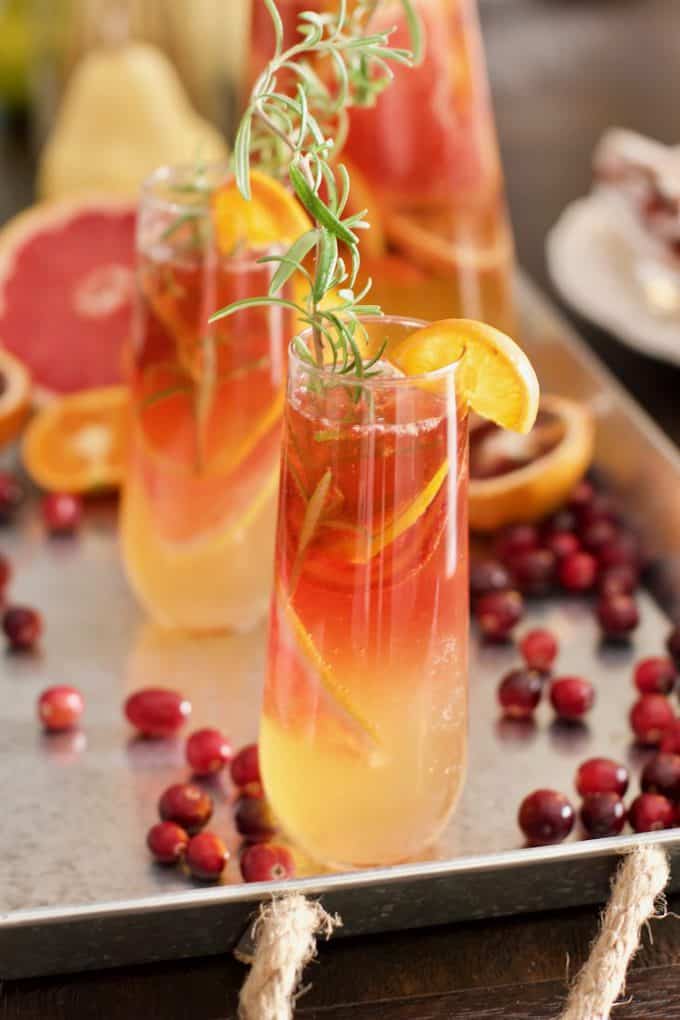 Winter Bellini in a beautiful glass with a sprig of rosemary