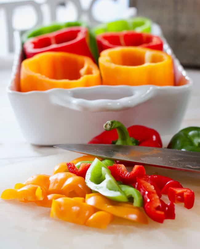 Colorful peppers chopped up on a cutting board