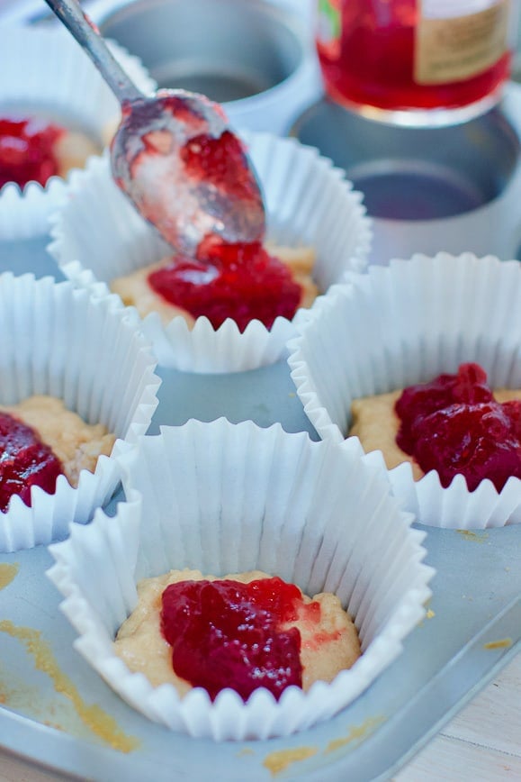 adding jelly to muffins before baking