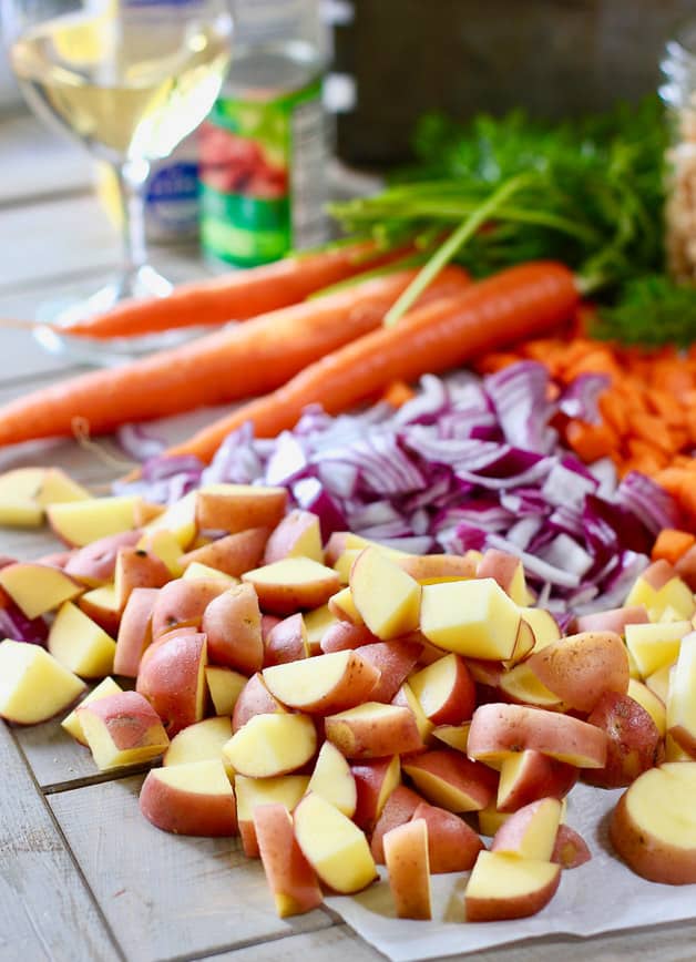 Potatoes, carrots and onion chopped up on a cutting board and ready to add to the Chorizo and White Bean Soup