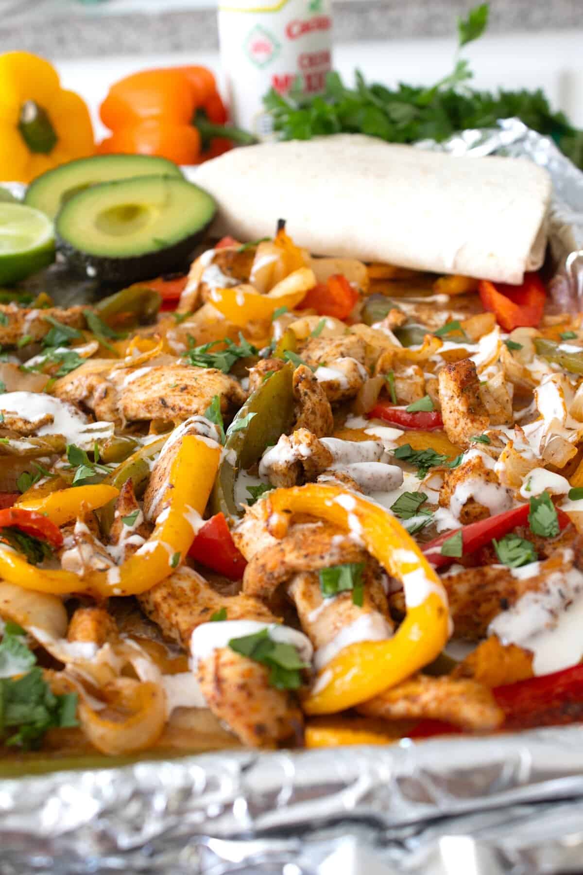 sheet pan fajitas with cream and avocado