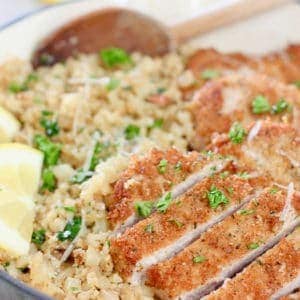 Sliced pork cutlets on top of cauliflower rice