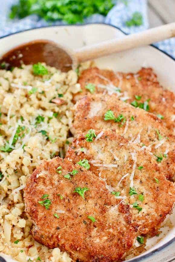 Crispy Pork Cutlets with savory cauliflower rice in a beautiful blue skillet