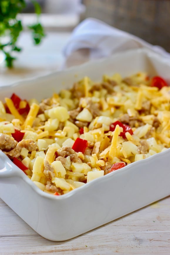 Breakfas Casserole in a white casserole dish ready to bake