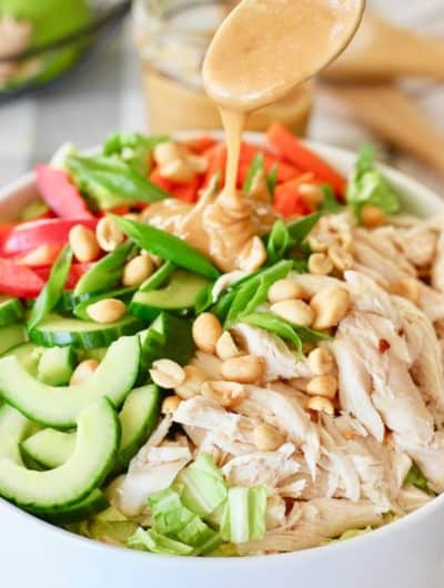 peanut dressing spooned onto thai peanut salad